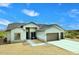 Exterior view of a single-story home with a three-car garage, desert landscaping, and a tiled roof at 36023 N 140Th St, Scottsdale, AZ 85262