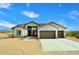 Tan single-story home with a two-car garage and desert landscaping at 36023 N 140Th St, Scottsdale, AZ 85262