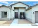 Front yard with a walkway leading to the entrance, rocking chairs, and desert landscaping at 36023 N 140Th St, Scottsdale, AZ 85262