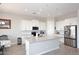 Kitchen with island, white shaker cabinets, stainless steel appliances, and dining area at 36023 N 140Th St, Scottsdale, AZ 85262