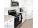 Close-up view of the kitchen's stainless steel appliances and white shaker cabinets at 36023 N 140Th St, Scottsdale, AZ 85262