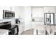 Modern kitchen featuring white cabinetry, stainless steel appliances, and a light quartz countertop at 36023 N 140Th St, Scottsdale, AZ 85262