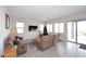 Living room with sliding glass doors, brown leather furniture, and large windows offering natural light at 36023 N 140Th St, Scottsdale, AZ 85262