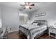 Bedroom with metal bedframe, ceiling fan, and wood-look flooring at 36248 W Cartegna Ln, Maricopa, AZ 85138