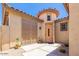 Private courtyard entry with a charming wooden door and security gate at 36248 W Cartegna Ln, Maricopa, AZ 85138