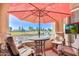 Balcony with patio furniture, umbrella, and a view of the golf course and lake at 3800 S Cantabria Cir # 1023, Chandler, AZ 85248