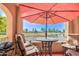 Covered balcony with outdoor grill, table, chairs, and umbrella with golf course views at 3800 S Cantabria Cir # 1023, Chandler, AZ 85248