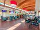 Clubhouse bar with TVs, comfortable seating, and wood beam ceiling at 3800 S Cantabria Cir # 1023, Chandler, AZ 85248