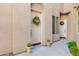 Front door with festive wreaths and potted plants at 3800 S Cantabria Cir # 1023, Chandler, AZ 85248