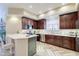 Modern kitchen with dark wood cabinets, stainless steel appliances, and white countertops at 3800 S Cantabria Cir # 1023, Chandler, AZ 85248
