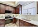 Updated kitchen with stainless steel appliances, a window over the sink, and white countertops at 3800 S Cantabria Cir # 1023, Chandler, AZ 85248