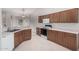 Kitchen featuring wood cabinets, white appliances, and tile flooring at 4010 N 156Th Ln, Goodyear, AZ 85395