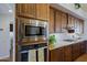 Kitchen features stainless steel microwave and oven, and granite countertop at 42609 N 19Th St, New River, AZ 85087