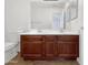 Bathroom featuring dual sinks, wood vanity, and tile flooring at 44792 W Miraflores St, Maricopa, AZ 85139
