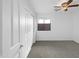 Carpeted bedroom with a ceiling fan and windows at 44792 W Miraflores St, Maricopa, AZ 85139