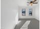 Bright bedroom with a ceiling fan, multiple windows, and carpeted flooring at 44792 W Miraflores St, Maricopa, AZ 85139