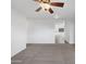 Open living room with plush carpet and a view of the dining area at 44792 W Miraflores St, Maricopa, AZ 85139