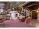 Inviting outdoor patio area with a fire pit and string lights at 4721 E Wilshire Dr, Phoenix, AZ 85008