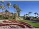 Grand entrance to the community with palm trees, water features, and flower beds at 5000 E Camelback Ridge Rd # 406, Scottsdale, AZ 85251