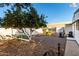 Backyard with orange tree, garden beds, and storage shed at 5502 E Baywood Ave, Mesa, AZ 85206