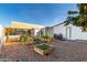 Backyard garden with raised beds, orange tree, and storage shed at 5502 E Baywood Ave, Mesa, AZ 85206
