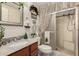 Bathroom featuring a granite vanity, a walk-in shower, and festive holiday decorations at 5502 E Baywood Ave, Mesa, AZ 85206