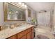 Bathroom with granite countertop, oak cabinets, and a combination tub and shower at 5502 E Baywood Ave, Mesa, AZ 85206