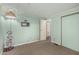 Second bedroom decorated in a soft green hue, featuring carpeted flooring and holiday decor at 5502 E Baywood Ave, Mesa, AZ 85206