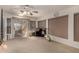 Bonus room with large windows, a mounted TV, exercise equipment, and access to the outdoors at 5502 E Baywood Ave, Mesa, AZ 85206