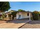 Exterior view of the home with attached carport and desert landscaping at 5502 E Baywood Ave, Mesa, AZ 85206