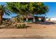 Charming single-story home with lush landscaping and a covered carport at 5502 E Baywood Ave, Mesa, AZ 85206