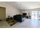 Bright living room with tile floors, ceiling fan, and sliding glass doors at 6803 W Cherry Hills Dr, Peoria, AZ 85345