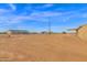 View of the house and neighboring property from the backyard at 735 E Hanna Rd, Eloy, AZ 85131