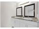 Double vanity bathroom with modern light fixture and granite countertops at 735 E Hanna Rd, Eloy, AZ 85131