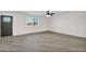 Living room with wood-look flooring, a ceiling fan, and a window at 735 E Hanna Rd, Eloy, AZ 85131