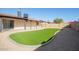 Backyard with artificial turf, gravel landscaping, and a block wall at 7419 W Corrine Dr, Peoria, AZ 85381