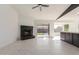 Living room with fireplace, tile flooring, and sliding glass doors to the backyard at 7419 W Corrine Dr, Peoria, AZ 85381