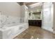 Spacious bathroom with a luxurious soaking tub, marble tile, and glass shower at 8146 E Wingspan Way, Scottsdale, AZ 85255