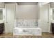 Modern bathroom with a soaking tub, marble tile, and dual vanities at 8146 E Wingspan Way, Scottsdale, AZ 85255