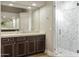 Bathroom with glass shower, dark wood cabinets, and marble countertops at 8146 E Wingspan Way, Scottsdale, AZ 85255