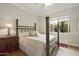 Bedroom featuring a four-poster bed, wood floors, and a decorative rug at 8146 E Wingspan Way, Scottsdale, AZ 85255