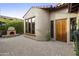 Inviting front entry with a fireplace and a wood door at 8146 E Wingspan Way, Scottsdale, AZ 85255