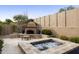 Relaxing hot tub and outdoor fireplace in a private backyard setting at 8146 E Wingspan Way, Scottsdale, AZ 85255