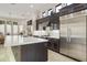 Kitchen with stainless steel appliances, dark wood cabinetry, and large island at 8146 E Wingspan Way, Scottsdale, AZ 85255