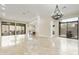 Spacious living room with tile floors and multiple sliding glass doors to the backyard at 8146 E Wingspan Way, Scottsdale, AZ 85255