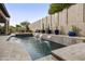 Tranquil backyard oasis featuring a pool with cascading waterfalls and lush landscaping at 8146 E Wingspan Way, Scottsdale, AZ 85255