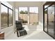 Sunroom or sitting room with large windows, a recliner, and backyard views at 8146 E Wingspan Way, Scottsdale, AZ 85255