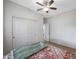 Bedroom featuring sliding closet doors, a ceiling fan, and wood-look flooring at 8214 S 15Th St, Phoenix, AZ 85042