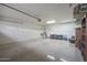 Well-lit two-car garage with storage racks and organizational features at 8214 S 15Th St, Phoenix, AZ 85042