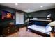 Bunk bed room with a TV and ample storage at 8304 E Gail Rd, Scottsdale, AZ 85260